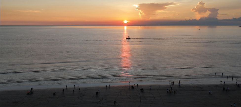 Kuakata Sea Beach Bangladesh at sunrise and sunset view with wide sandy shore and calm Bay of Bengal waves