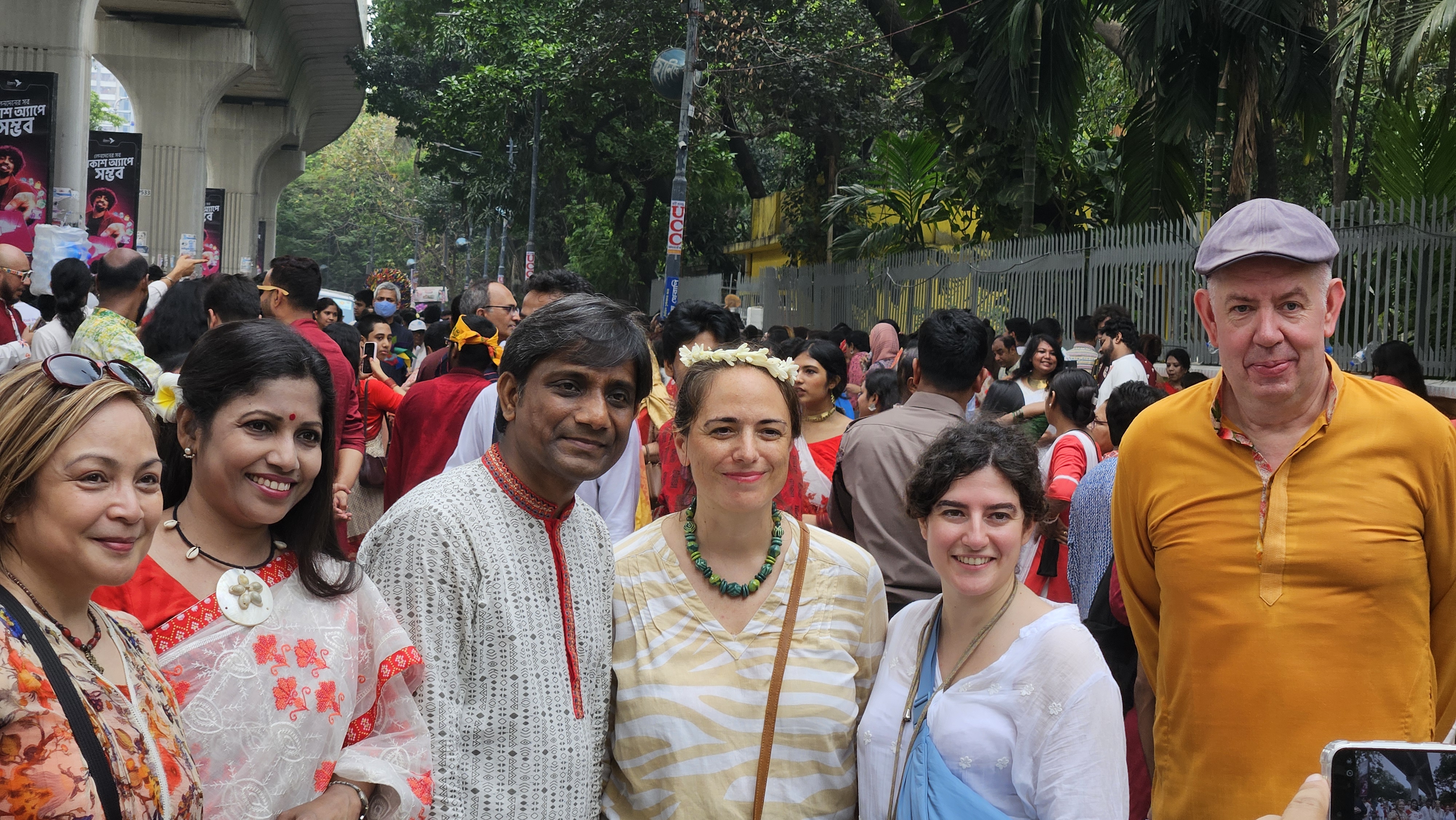 Foreign tourists celebrating Pohela Boishakh in Bangladesh wearing traditional Bengali clothes at Ramna Batamul cultural festival