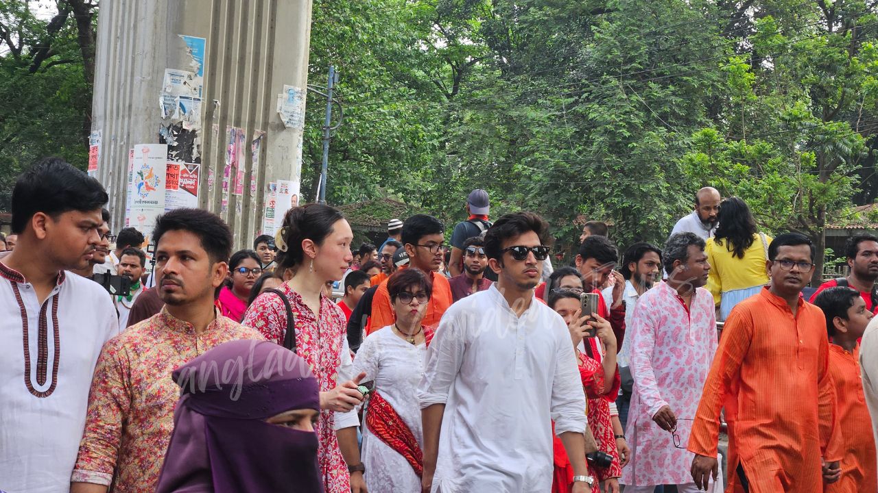 Japanese visitors joining Pohela Boishakh Mangal Shobhajatra in Bangladesh with colorful masks, folk art, and Bengali New Year celebration — captured by Bangladesh Guided Tours