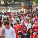Polish visitors taking part in Pohela Boishakh Mangal Shobhajatra in Bangladesh amid colorful traditional masks, folk designs, and Bengali New Year celebrations — Bangladesh Guided Tours