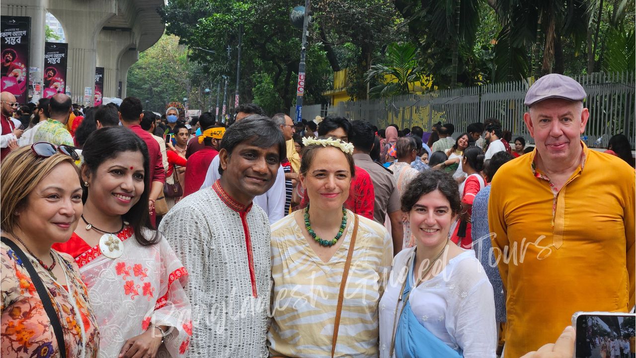 Foreign tourists celebrating Pohela Boishakh in Bangladesh wearing traditional Bengali clothes at Ramna Batamul cultural festival