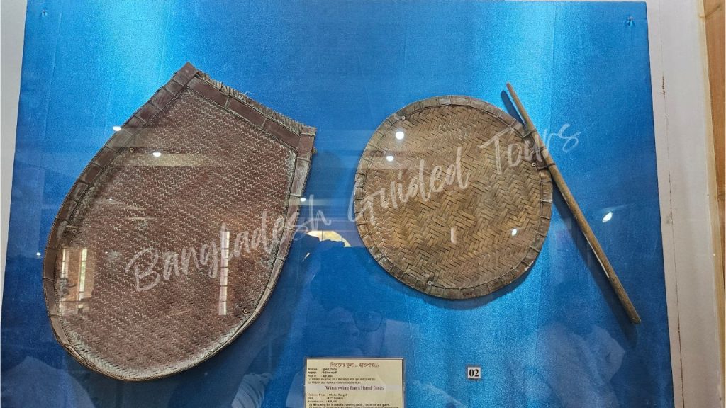 Traditional Bangladeshi hatpakha hand fan displayed inside Sonargaon Folk Art and Craft Museum heritage collection