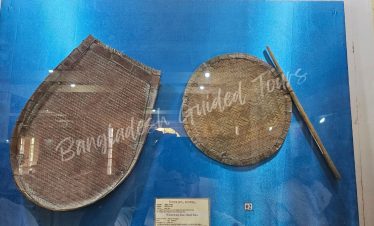 Traditional Bangladeshi hatpakha hand fan displayed inside Sonargaon Folk Art and Craft Museum heritage collection