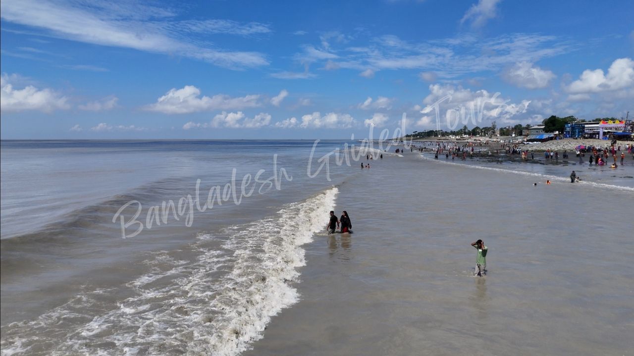 Endless shoreline of Cox’s Bazar sea beach under golden sunset sky